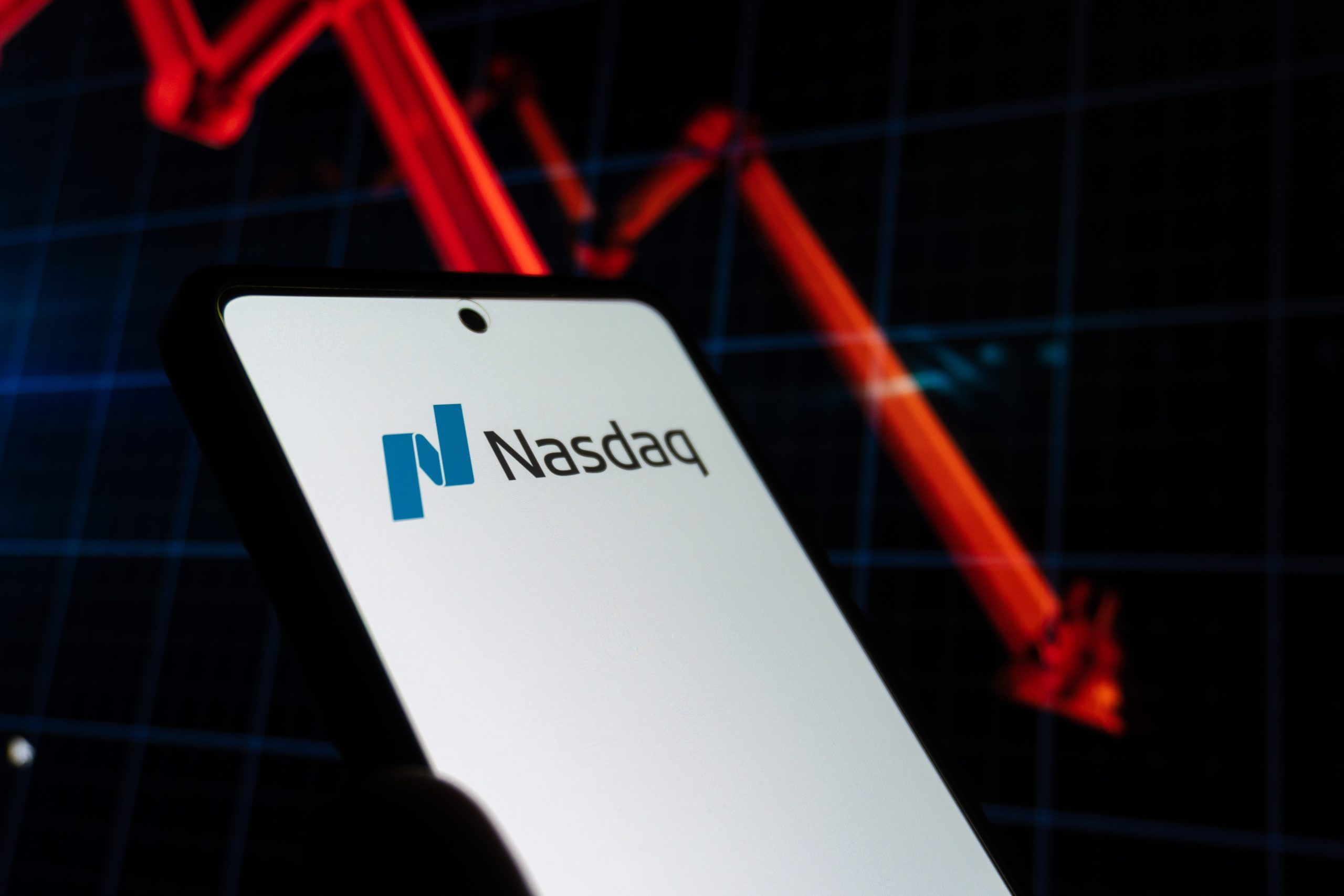 Smartphone screen showing the Nasdaq logo on a white display.